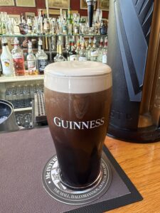 Freshly poured Guinness pint at McIntyre's Saloon Bar in Ballyshannon, with creamy head and pub backbar