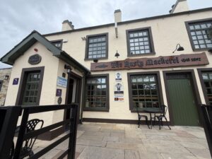 Exterior of The Rusty Mackerel pub, a traditional tourist bar near Slieve League with Guinness signage