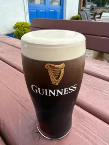 Salmon Inn full Guinness pint on an outdoor picnic table.