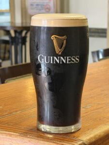 Perfectly poured glass of Guinness with creamy head set on bar at Annora