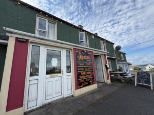 Annora Bar in Portnoo with vibrant red storefront and outdoor seating