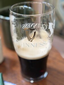 A mostly empty pint of Guinness in a classic tulip glass