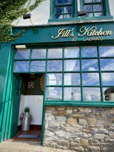 A green-painted restaurant named Jill's Kitchen at Laura's
