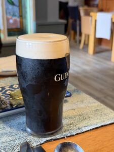 Guinness pint at Wild Stag, Dulrush Lodge pub, served in a clear glass with a creamy head