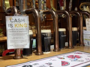 Wild Stag at Dulrush Lodge Guinness pint bar interior with cash-is-king sign and polished beer taps
