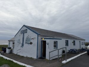 An Club pub exterior on Tory Island, remote Irish pub with Guinness reviews and sea view