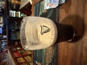 Guinness pint at An Club, Tory Island pub interior with bar counter and friendly island atmosphere