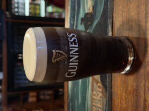Guinness pint at An Club on Tory Island, a perfectly poured stout in a cozy Irish bar interior