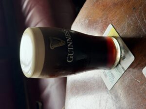 Guinness pint with creamy head on a pub table at The Anglers Rest, Kinlough, Ireland
