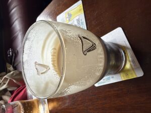 Close-up of a Guinness pint on a pub table at The Anglers Rest, Kinlough, with smooth dark stout and creamy head